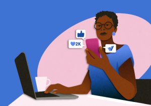 an image of a woman checking her phone displaying like icons next to it while a laptop rests on her desk to signify the impact of social media on remote work productivity